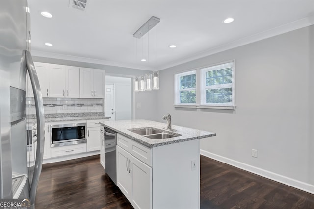 kitchen featuring pendant lighting, white cabinetry, sink, a kitchen island with sink, and stainless steel appliances