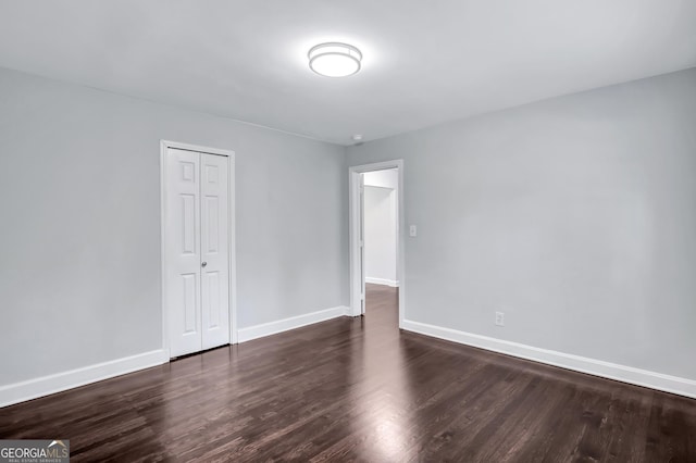 unfurnished room featuring dark hardwood / wood-style floors