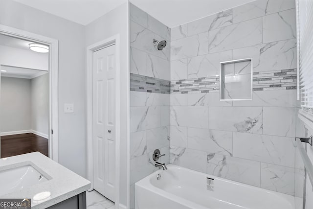 bathroom featuring vanity and tiled shower / bath combo