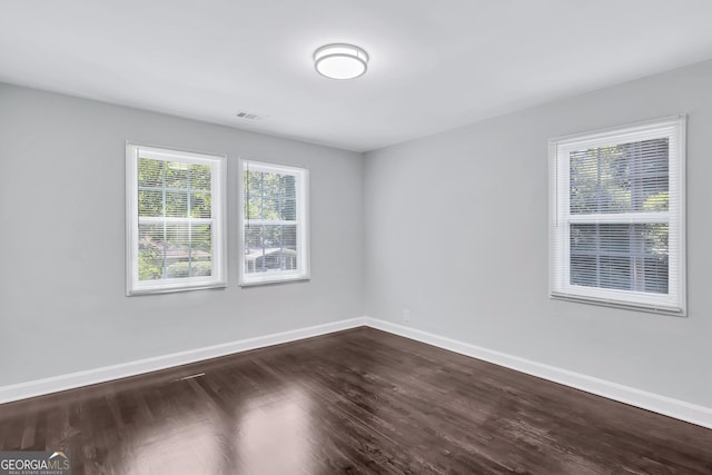 spare room featuring dark hardwood / wood-style flooring