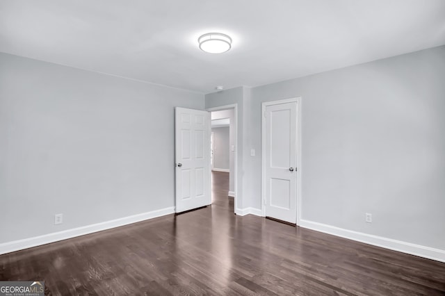 spare room featuring dark hardwood / wood-style flooring