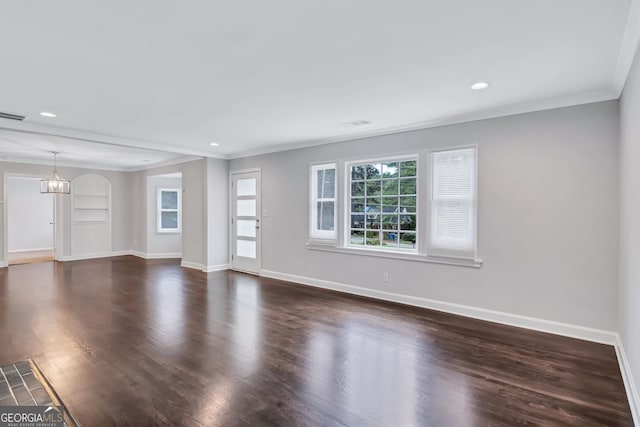 unfurnished living room with crown molding, a chandelier, dark wood-type flooring, and built in features