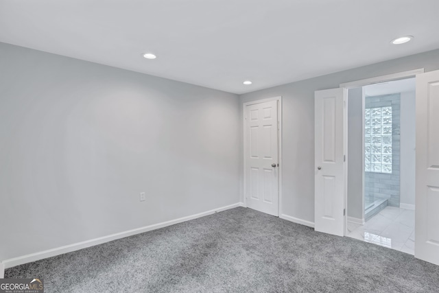 unfurnished bedroom featuring light colored carpet