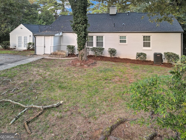 back of house with a yard and central AC unit