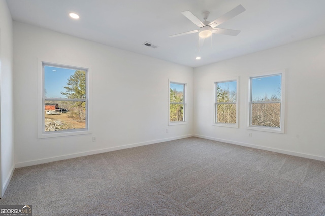 empty room featuring carpet flooring and ceiling fan