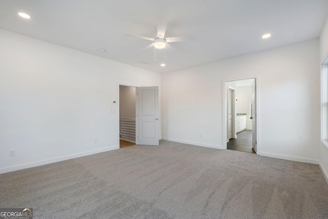 unfurnished bedroom featuring ceiling fan, connected bathroom, and carpet