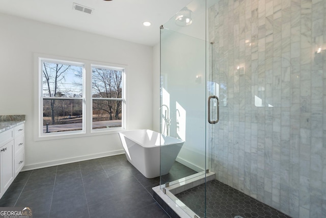 bathroom featuring independent shower and bath, vanity, and tile patterned floors