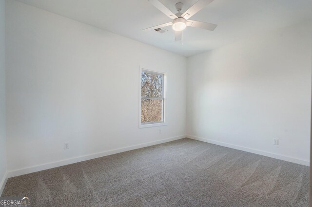 carpeted empty room featuring ceiling fan