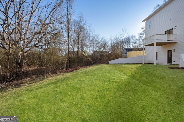 view of yard with a balcony