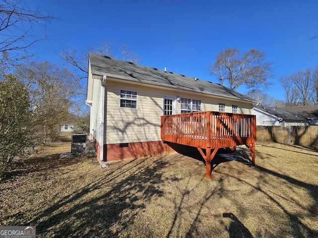 back of house featuring a yard and a deck