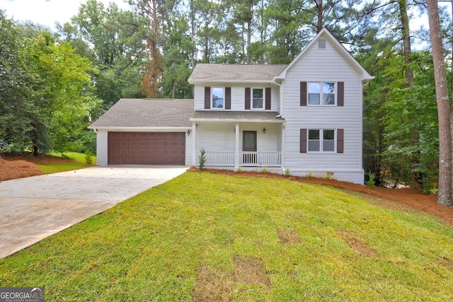 view of front of home with a garage, a front yard, and covered porch