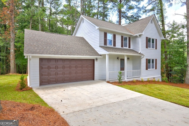 front of property featuring a garage, a front lawn, and a porch