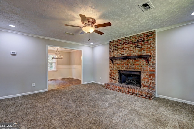 unfurnished living room with ornamental molding, carpet flooring, a brick fireplace, and a textured ceiling