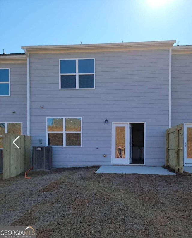 rear view of property with central AC and a patio area