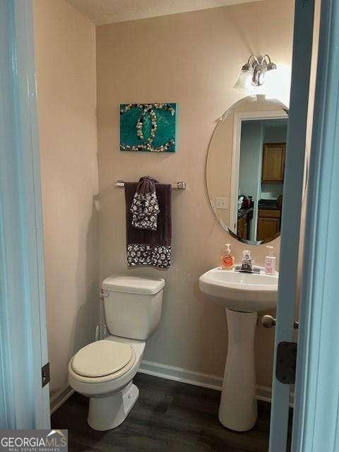 bathroom featuring hardwood / wood-style floors, sink, and toilet