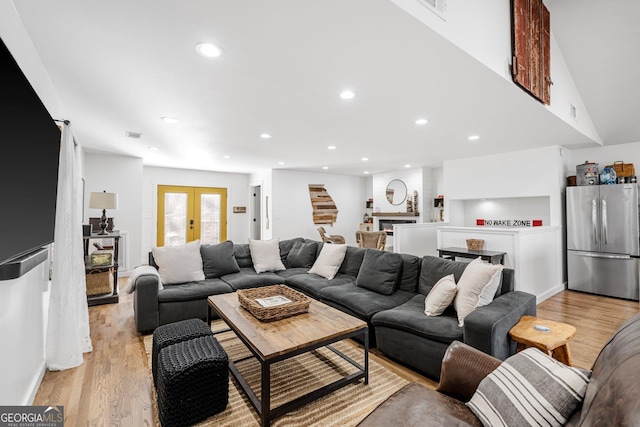 living room featuring light wood-type flooring and french doors