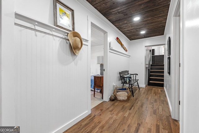 corridor with crown molding, hardwood / wood-style floors, and wooden ceiling