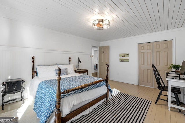 bedroom with crown molding, light hardwood / wood-style flooring, and wooden ceiling