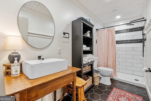 bathroom featuring sink, curtained shower, tile patterned floors, and toilet