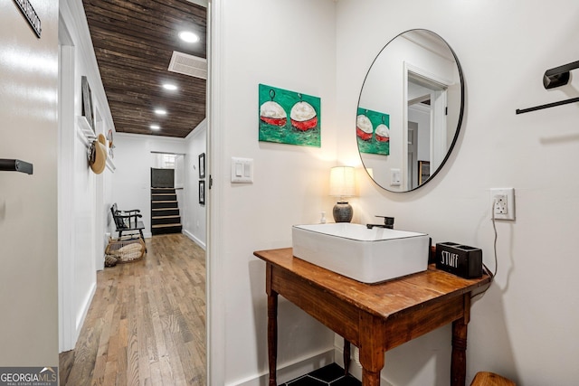 interior space featuring sink, wood-type flooring, and wooden ceiling