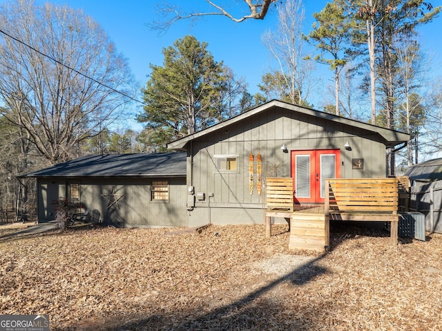 view of front facade with central AC, french doors, and a deck