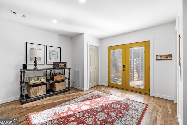 doorway to outside with french doors and hardwood / wood-style flooring