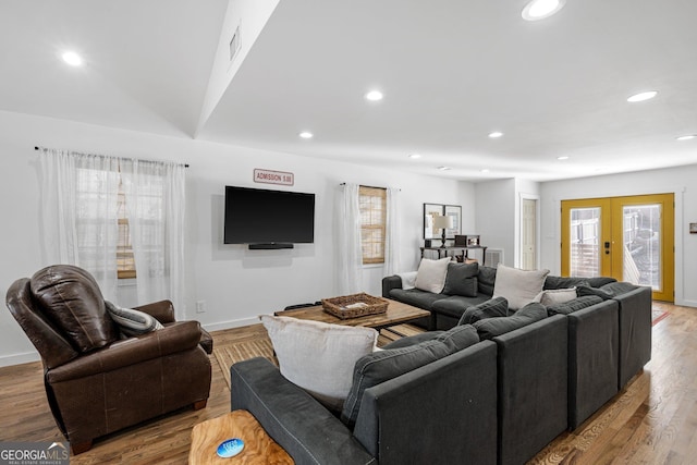 living room featuring light hardwood / wood-style floors and french doors