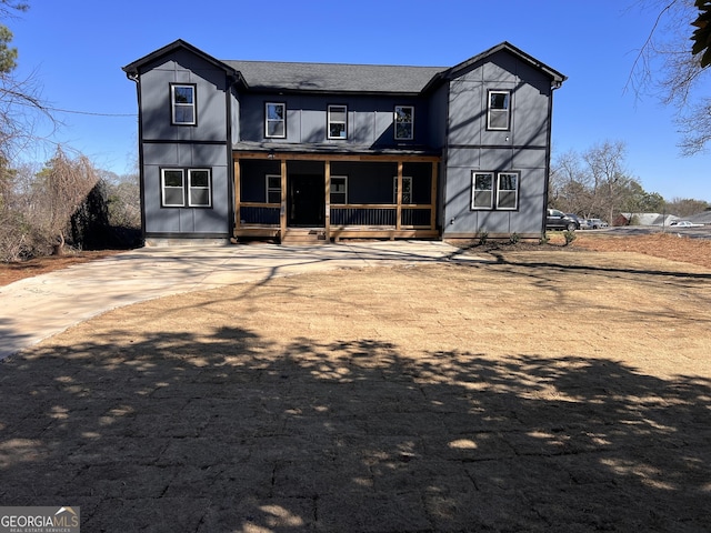 rear view of property with covered porch