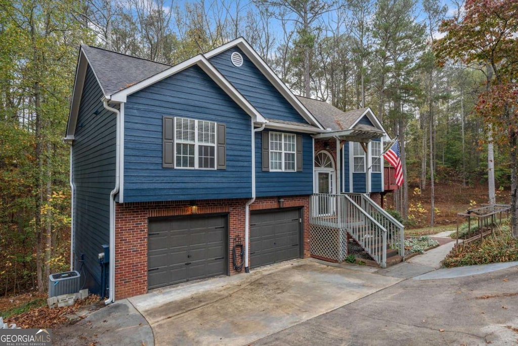 bi-level home with cooling unit and a garage