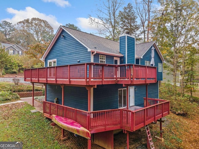 rear view of house featuring a deck