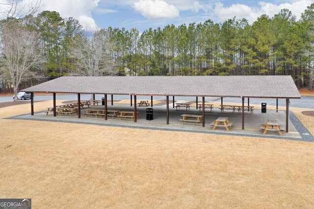 rear view of house featuring a balcony, a lawn, and a patio area