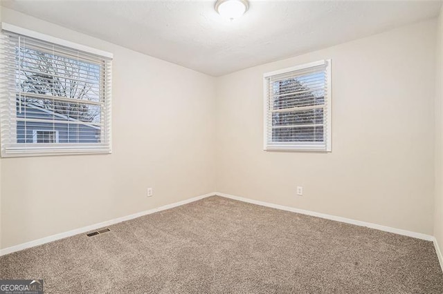 unfurnished room featuring carpet flooring