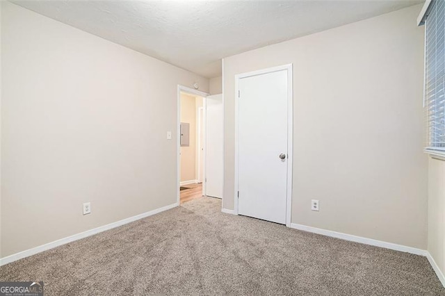 unfurnished bedroom with light colored carpet