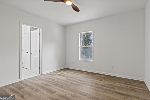 empty room featuring ceiling fan and light wood-type flooring