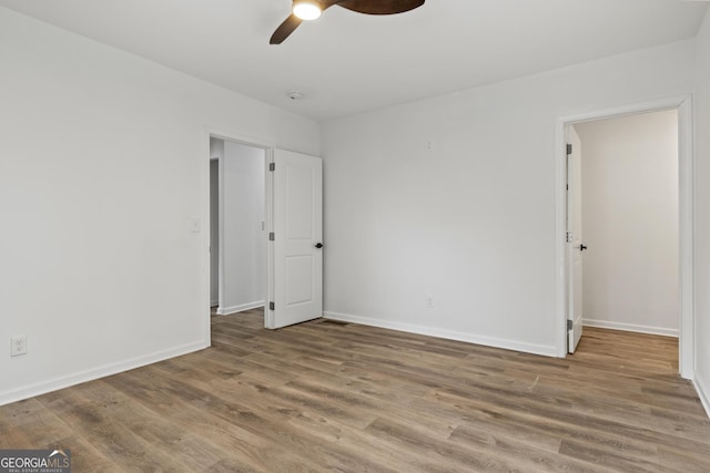 unfurnished bedroom featuring wood-type flooring and ceiling fan