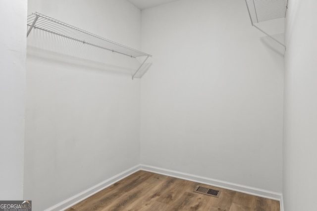 walk in closet featuring hardwood / wood-style flooring