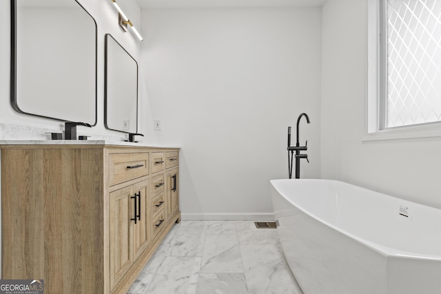 bathroom with vanity and a tub