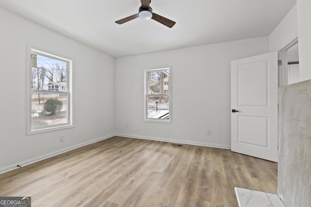 empty room featuring ceiling fan and light wood-type flooring