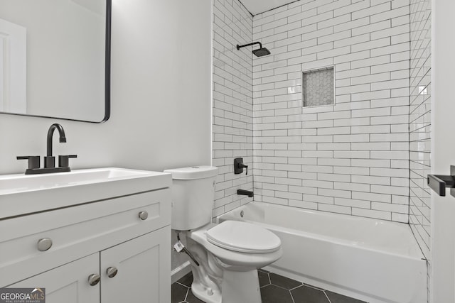 full bathroom with vanity, tiled shower / bath combo, tile patterned floors, and toilet