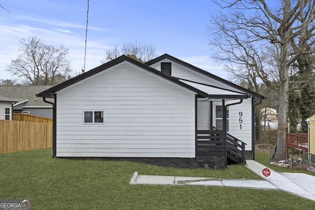 view of side of property with a lawn