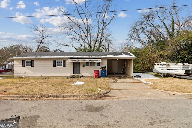 view of front facade with a carport and a front lawn