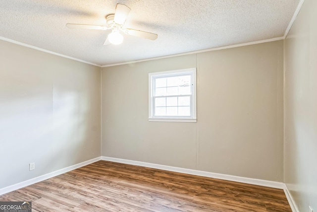 spare room featuring a textured ceiling, wood-type flooring, ornamental molding, and ceiling fan