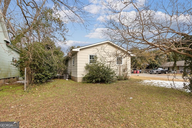 view of home's exterior with a lawn