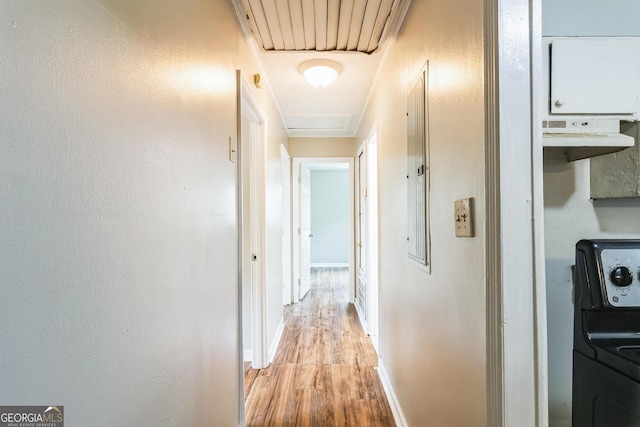 corridor with washer / clothes dryer and light hardwood / wood-style floors