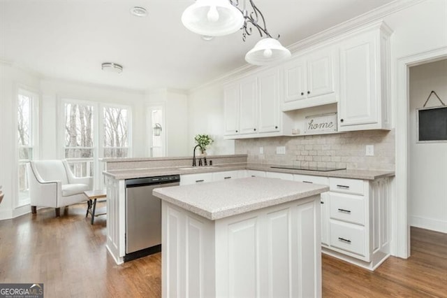 kitchen featuring a center island, dishwasher, kitchen peninsula, pendant lighting, and white cabinets