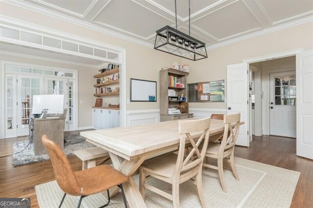 dining room with hardwood / wood-style flooring, crown molding, coffered ceiling, and french doors