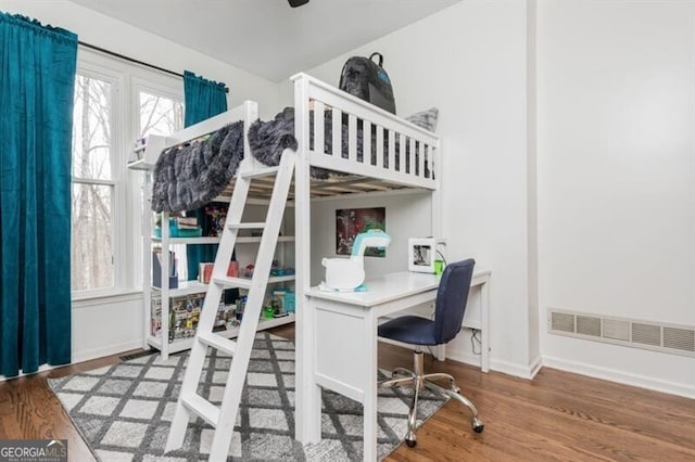 bedroom with wood-type flooring