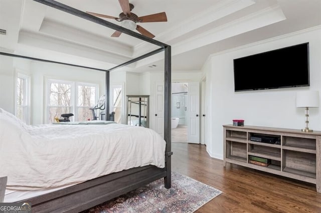 bedroom featuring ornamental molding, dark hardwood / wood-style floors, ceiling fan, and a tray ceiling