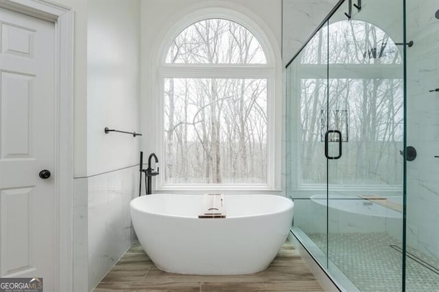 bathroom featuring independent shower and bath