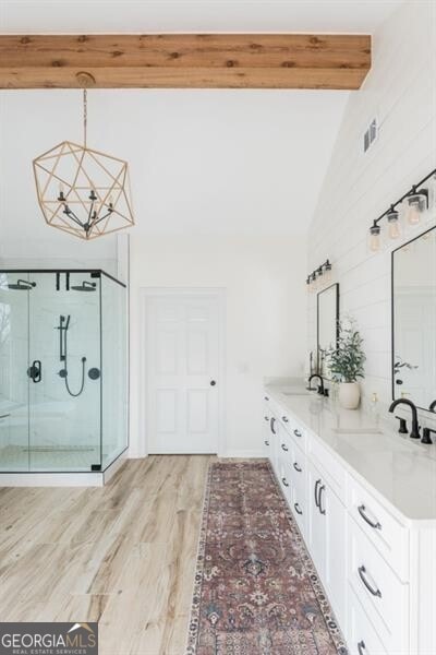 bathroom featuring walk in shower, vaulted ceiling with beams, vanity, a notable chandelier, and hardwood / wood-style flooring